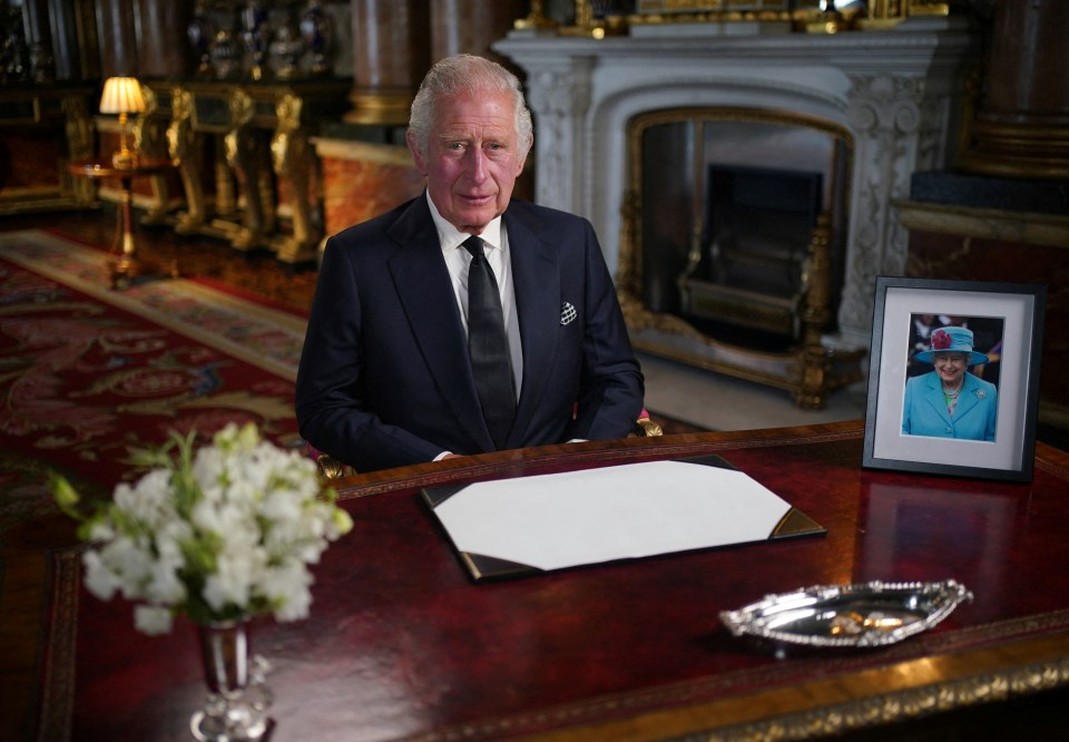 A picture of The Queen sat beside her son at his desk as he addressed the nation as King for the first time