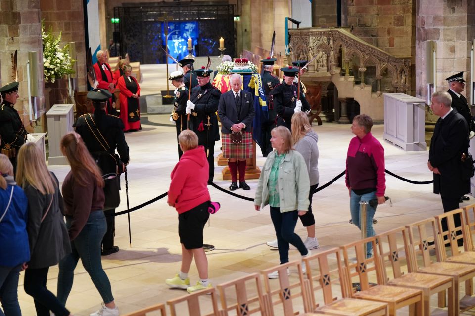 Mourners filed past the Queen's coffin yesterday as King Charles stood guard