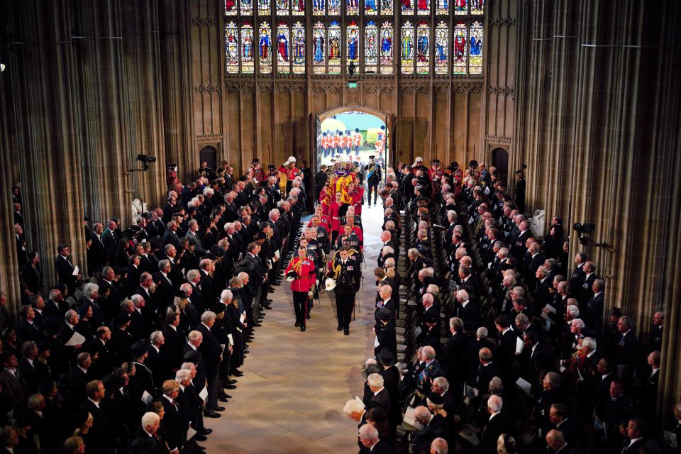 Charles and members of the royal family follow behind the Queen's coffin of as it is carried into St George’s Chapel