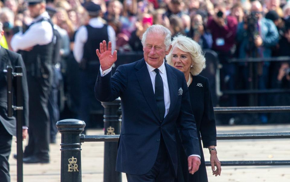 The new King greeted mourners at Buckingham Palace with wife Camilla today