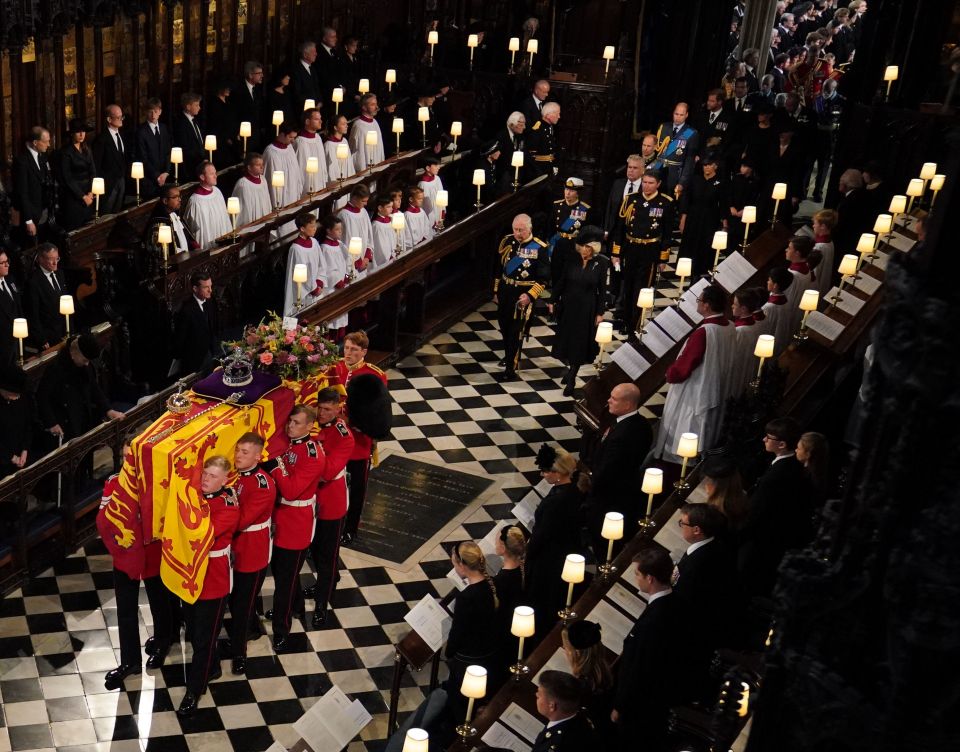 The coffin of the Queen followed by her grieving family through St George's Chapel