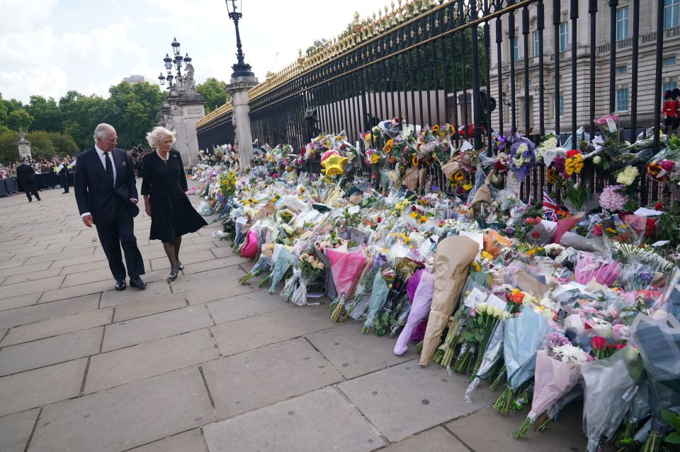 King Charles III and the Queen view tributes left outside Buckingham Palace