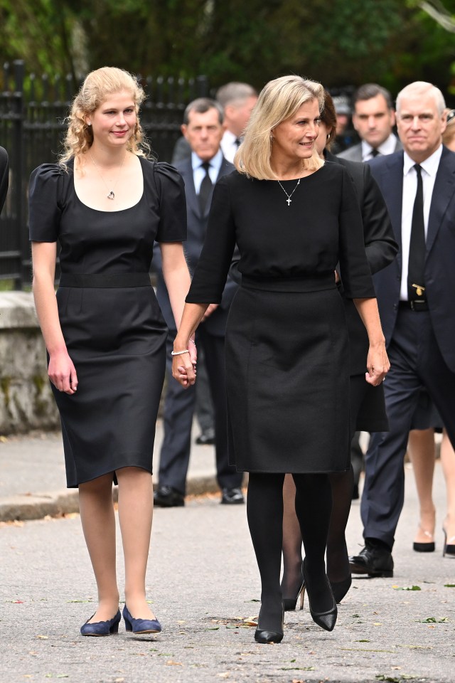 The Queen's 'favourite grandchild' Lady Louise clasped the hand of her mother Sophie Wessex as they attended a service at Balmoral today