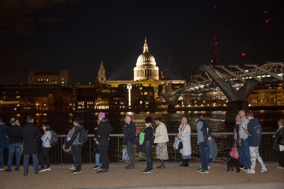 Members of the public queue opposite St Paul's Cathedral last night