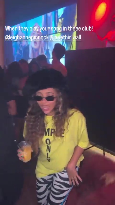 Jade held her drink as she danced in a 'simple only' T-shirt