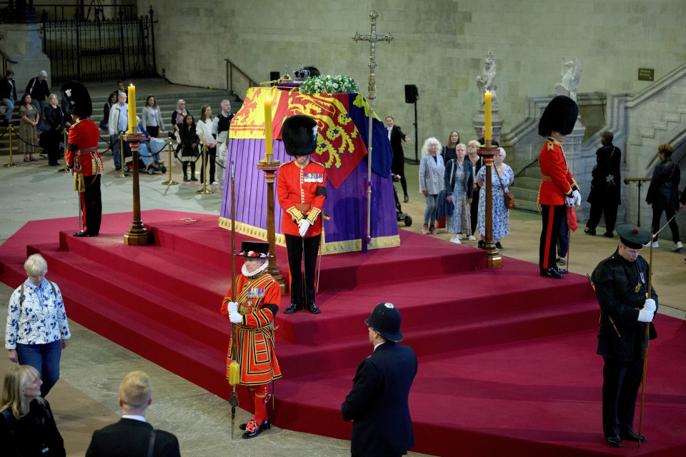 Mourners file past the Queen's coffin and pay their respects at Westminster Hall