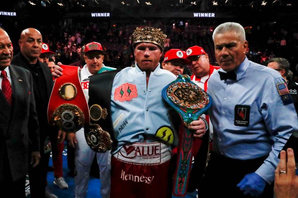 Canelo Alvarez poses with his undisputed titles