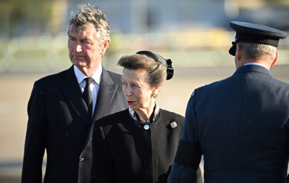 Princess Anne and husband Vice-Admiral Sir Tim watch as pallbearers carry the Queen's coffin to the jet