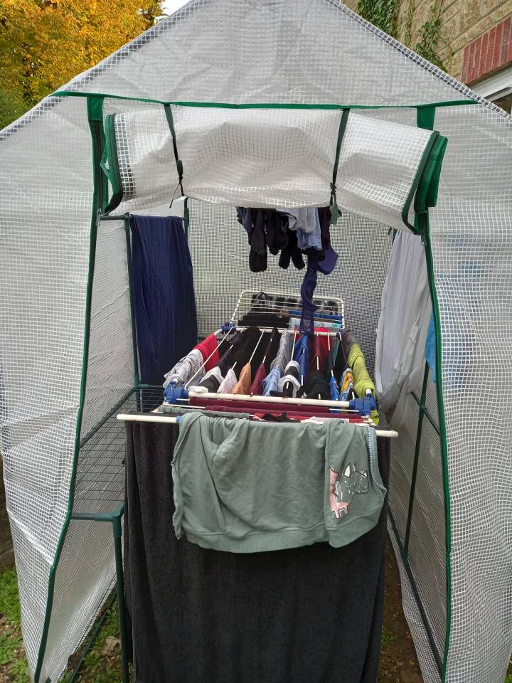 A woman showed how she dries her clothes in a plastic greenhouse