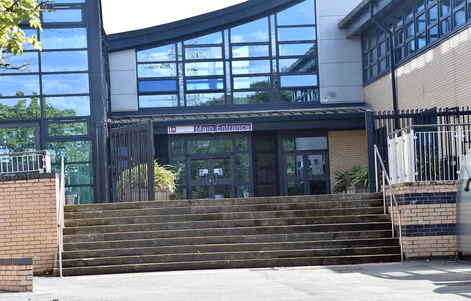 The main entrance to the school where the main doors to the toilets have been taken off