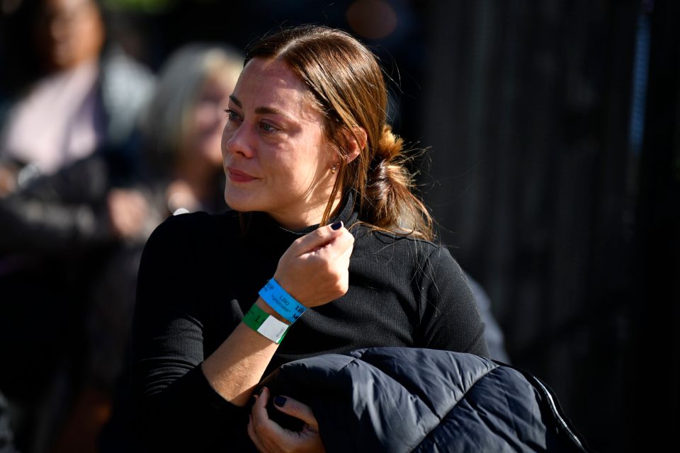 This woman appears tearful as she waits in line to say goodbye to the Queen