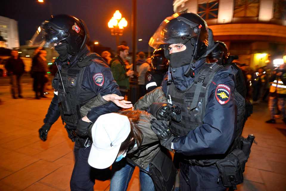 A demonstrator being dragged away in Moscow