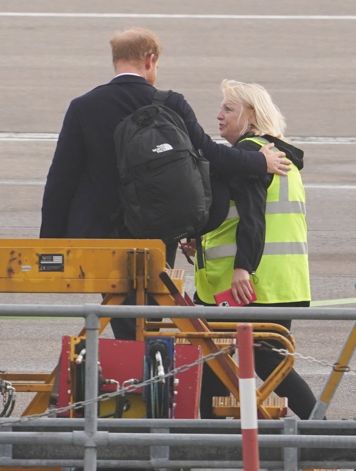 Prince Harry was comforted by airport staff as he boarded the flight home