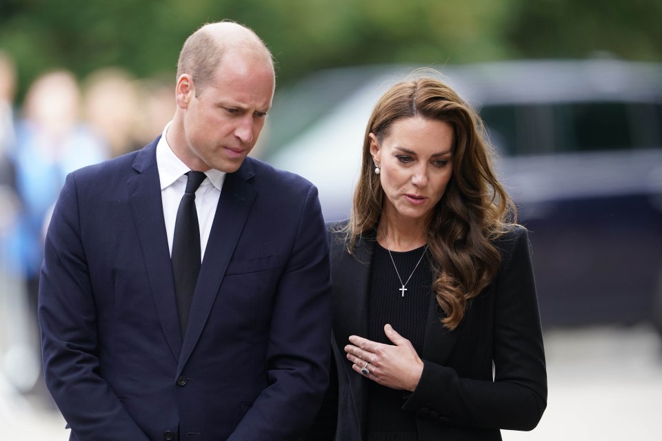 The Prince and Princess of Wales looking at the many tributes left at the Norfolk Gate