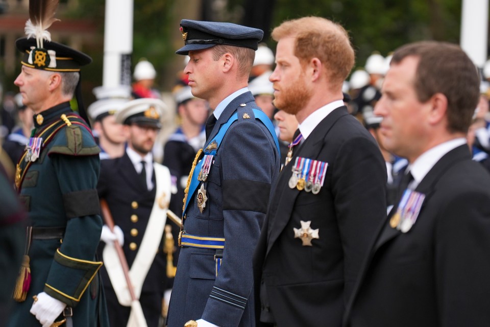 Princes William and Harry following a gun carriage carrying the coffin of their grandmother