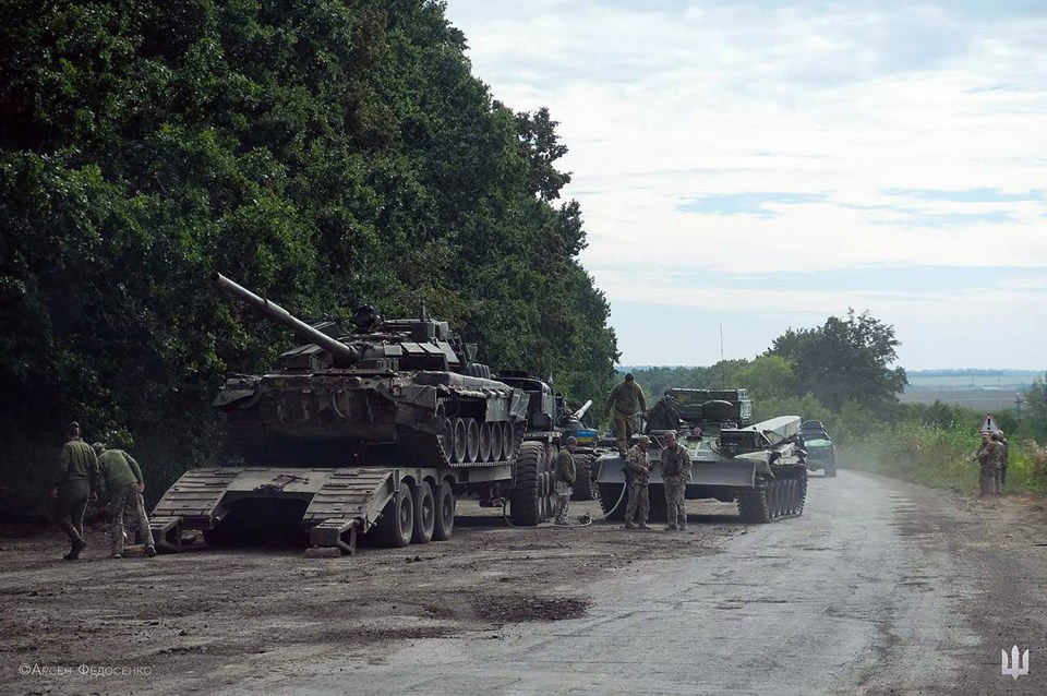 A Russian tank being towed away to be used by the tanks