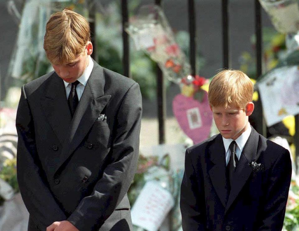 The brothers bowing their heads at their mother's funeral service in 1997