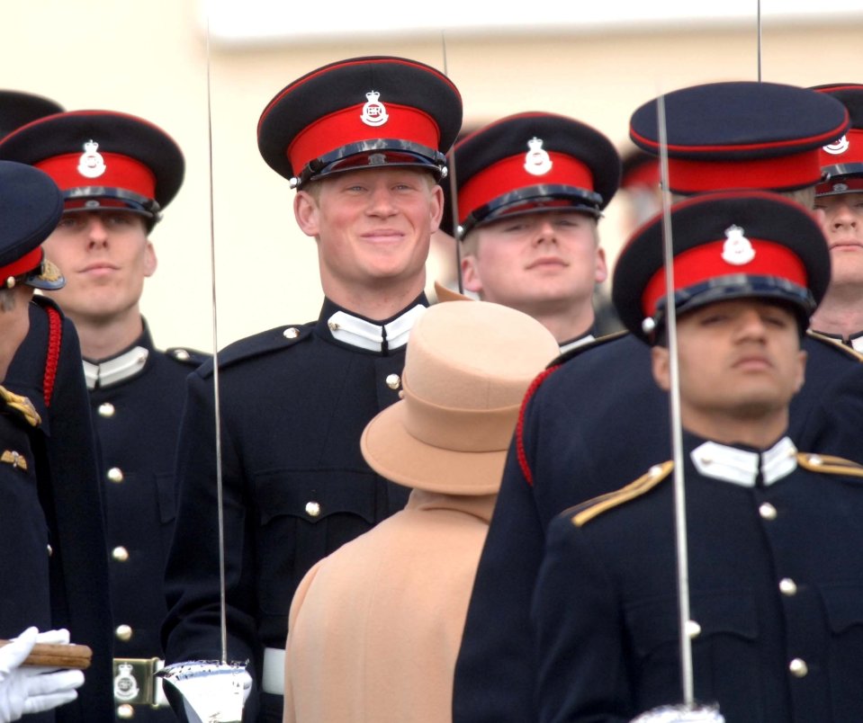 Prince Harry struggles to contain his smile as the Queen inspects his passing-out parade at Sandhurst in 2006