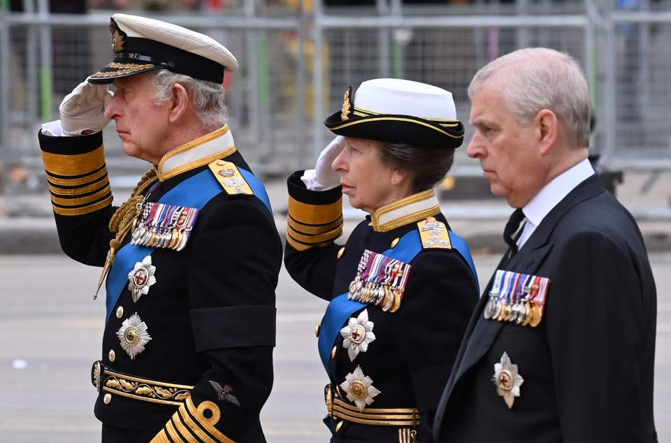 Prince Andrew stands alongside Princess Anne and King Charles III