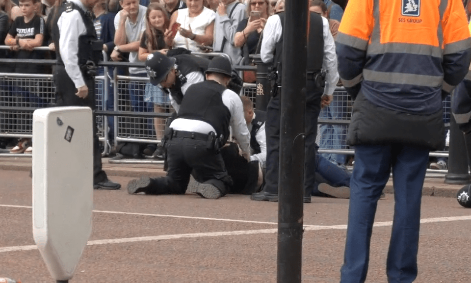 The suspect was tackled the ground after hopping a barrier