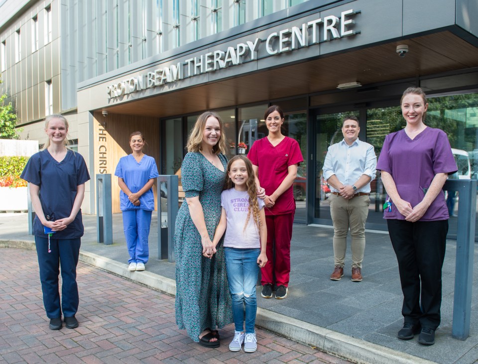 Amelie Fielding and mum Amy (centre) with the team at the Proton Beam Therapy Centre