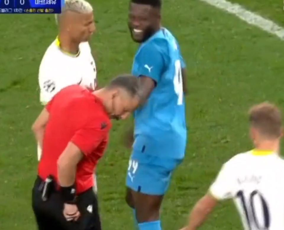 Referee Slavko Vincic goes to get his red card out of his pocket