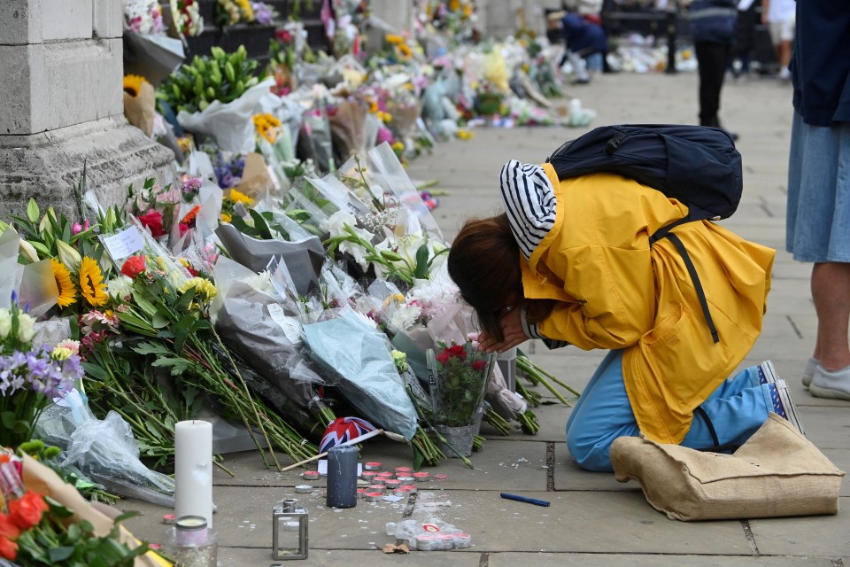 A woman mourns in front of Buckingham Palace