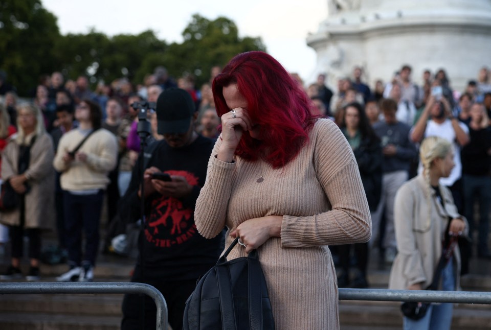 A mourner outside the Palace was unable to contain her emotion