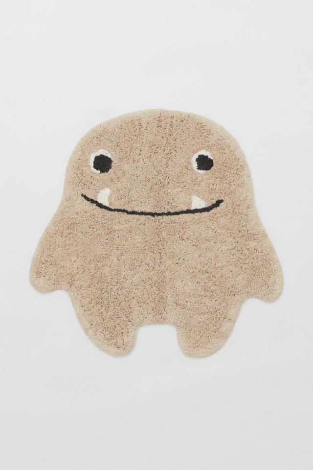 Give little terrors something to smile about with this cute monster-shaped rug