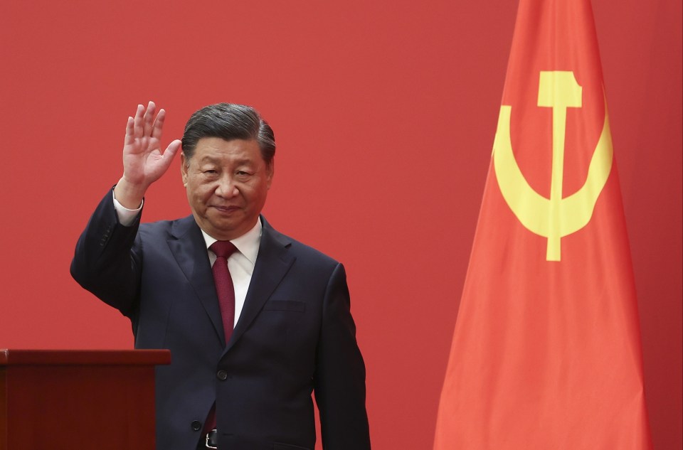 Chinese President Xi Jinping waves as he is appointed 'Emperor for Life'