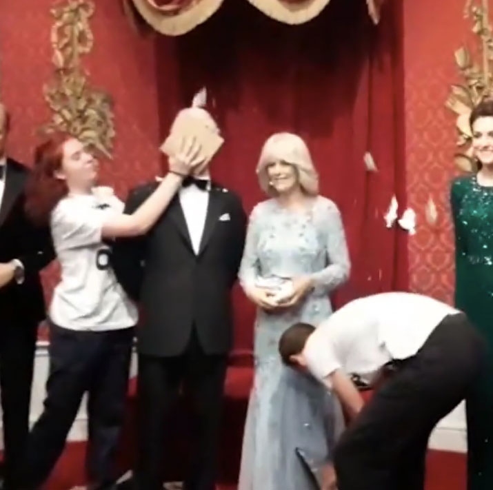 Shocking pictures showed the eco-idiots slam a cake into the waxwork of Prince Charles’ face