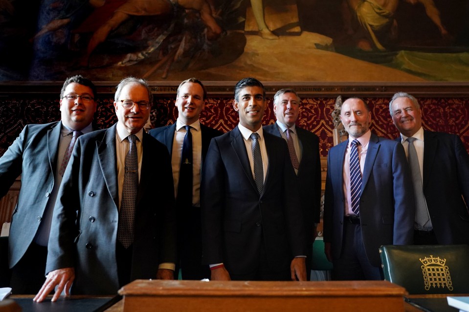 Rishi Sunak stands with members of the 1922 committee of backbench MPs