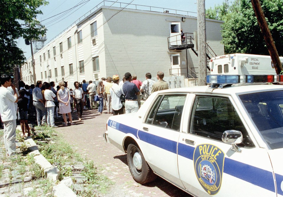 Neighbours gather at an apartment building on July 24, 1991 as police probed Dahmer