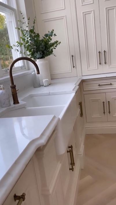 Theres's a double sink next to the huge kitchen island