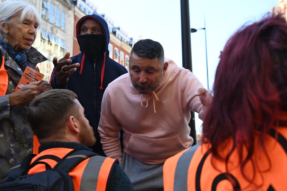 An angry motorist talking to an activist blocking a road in Knightsbridge