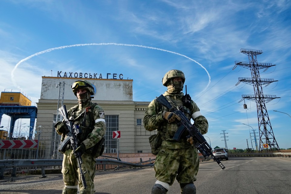 Russian troops guard an entrance of the Kakhovka Hydroelectric Station