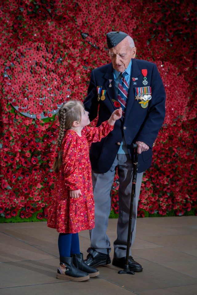 Maya Reynard, 6, gives D-Day veteran Bernard Morgan, 98, a poppy