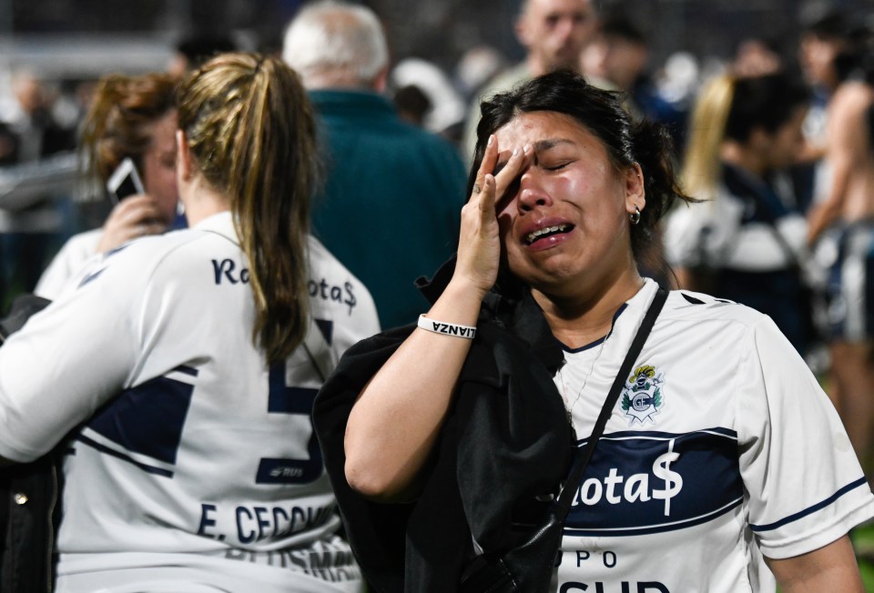 Gimnasia fans react to tear gas in the stands in their recent match against Boca Juniors