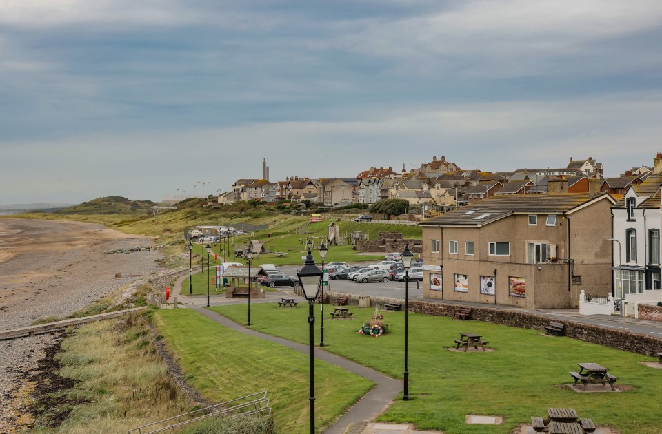 The seafront has the towers in the distance