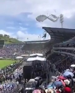 Hilarious footage has emerged of four parachuters crash landing at a celebration