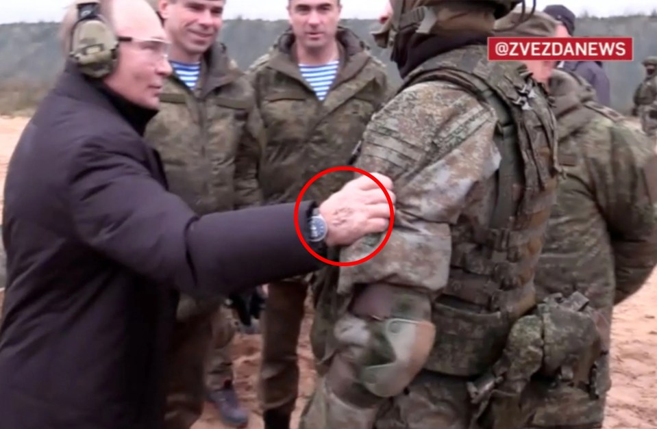 A mark on Putin's hand in this picture could be a sign of track marks from IVs, a journalist has claimed