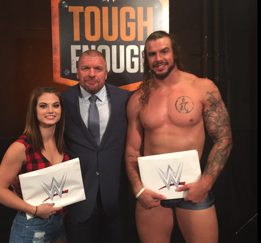 Sara Lee pictured receiving her WWE contract from the legendary Triple H (centre)