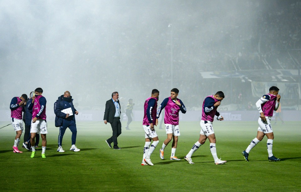 Players leave the field after the game is called off