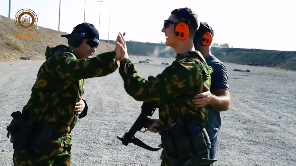 Adam high-fiving his brother on the range