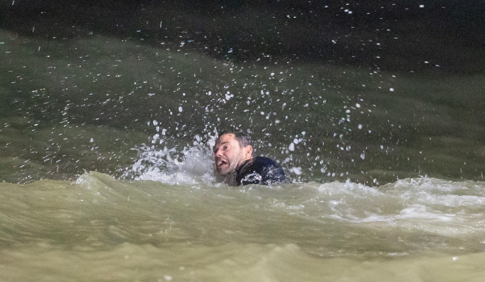 Mick scrambles in the sea