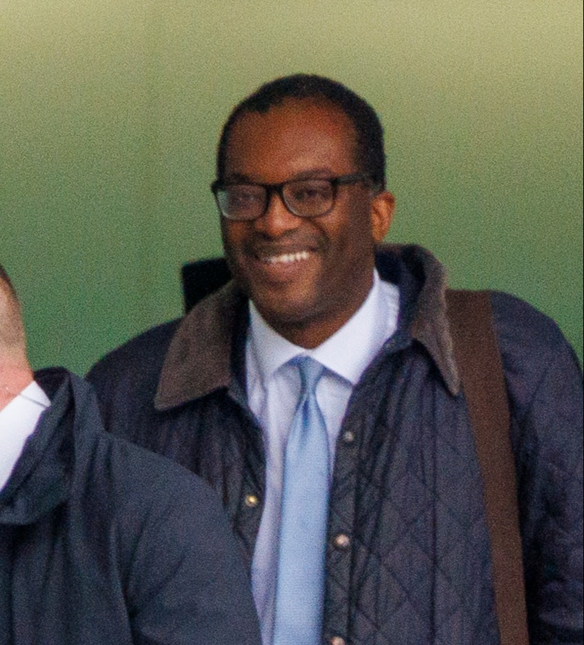 Kwasi Kwarteng at the airport as he got into his chauffeur-driven car to be taken back to No10 for showdown talks where he already knew his fate