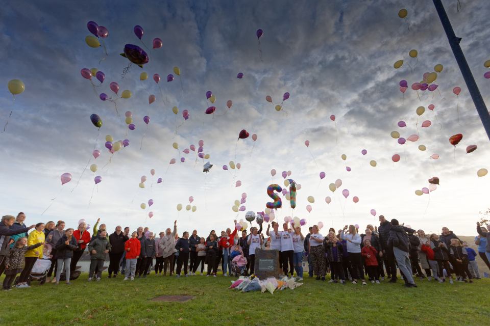 Relatives and friends release balloons in memory of Diane, Shauna and Sarah Jane