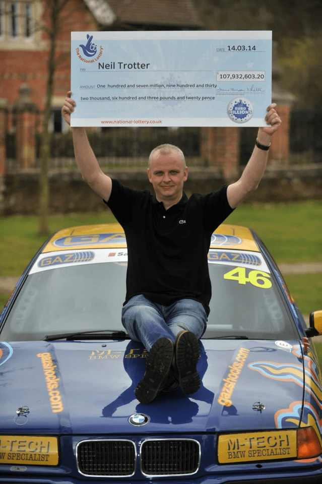 Neil Trotter on a racecar's hood after his bumper win