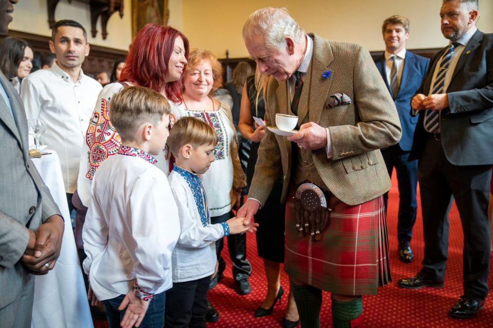 King Charles yesterday shrugged off a storm over the new series of Netflix drama The Crown — as he enjoyed a cuppa with refugees