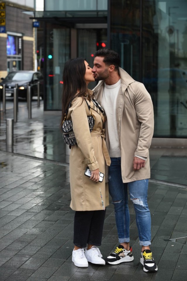 The loved-up couple couldn't resist stopping for a cheeky kiss